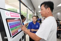 Des jeunes sont mobilisés pour soutenir les usagers au Centre de services administratifs de l'arrondissement de Thu Duc, à Hô Chi Minh-Ville. Photo : VNA