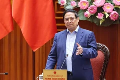 Le Premier ministre Pham Minh Chinh préside une réunion de la Permanence du gouvernement visant à évaluer la situation et à mettre en œuvre de mesures urgentes pour remédier aux conséquences du typhon n°11 (Matmo) et des inondations qui ont suivi. Photo : VNA