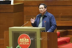 Le Premier ministre Pham Minh Chinh clarifié de nombreuses questions concernant la situation socio-économique, le budget d’État... lors d'un débat à l'Assemblée nationale. Photo : VNA