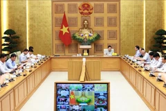 Le Premier ministre Pham Minh Chinh préside la 15ᵉ réunion du Comité national de lutte contre la pêche illégale, non déclarée et non réglementée (INN), tenue en ligne le 30 septembre. Photo : VNA