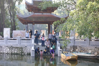 Des petites carpes rouges sont relâchés dans lac Van (Littérature), à Dông Da, Hanoi pour amener les Génies du Foyer au Ciel, selon la croyance. Photo : VNA