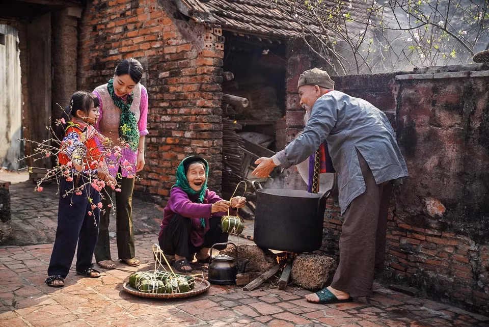 Lorsque l’on parle du Têt, on pense tout de suite au banh chung (gâteau de riz gluant carré). Le processus de fabrication est une opportunité pour la famille de se réunir. Assis autour du feu, ses membres veillent une grande partie de la nuit à la cuisson en se racontant leurs histoires pendant l’année écoulée. Les liens familiaux sont ainsi renforcés. Photo: VNA