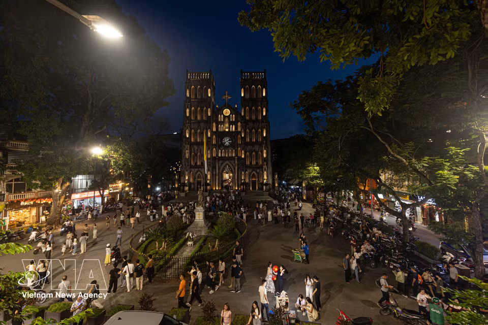L'espace architectural de la cathédrale de Hanoï se transforme en un lieu culturel et de divertissement animé pour les touristes vietnamiens et étrangers lorsque la ville s'illumine.
