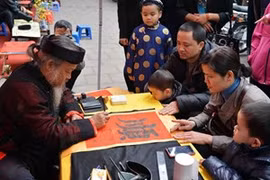 Demander une calligraphie à l'occasion du Nouvel An est un beau trait culturel de la tradition des Vietnamiens. Photo : VNA