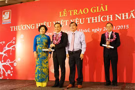 Mme Nguyên Thi Hông, à côté des représentants d'entreprises primées lors de la cérémonie de remise du prix «Marque préférée du Vietnam en 2014». 