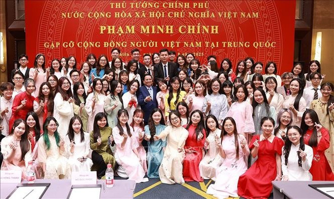 Le Premier ministre Pham Minh Chinh et des représentants de la communauté vietnamienne en Chine. Photo : VNA 2-7878.jpg