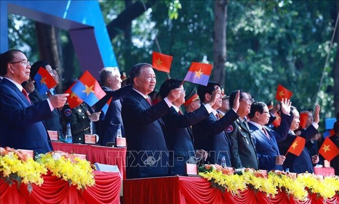 Le secrétaire général du Parti To Lam et des dirigeants regardent le défilé miliaitre en célébration de la réunification nationale. Photo : VNA 2.jpg
