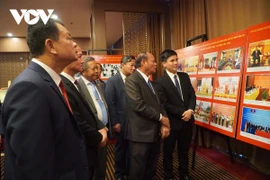 Les délégués visitent le stand d’exposition. Photo : VOV
