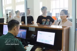 Des gardes-frontières à Tan Thanh (province de Lang Son) saisissent les données des passagers à l'entrée et à la sortie. Photo : VNA