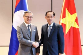 Le ministre vietnamien des AE Lê Hoài Trung (droite) et son homologue lao, Thongsavanh Phomvihane. Photo: VNA
