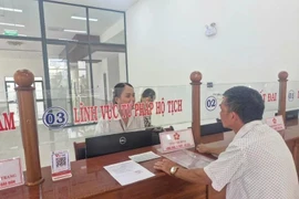 Un homme dépose ses demandes le jour de l'expérimentation du modèle d'administration locale à deux niveaux, dans le quartier de Pleiku, à Gia Lai. Photo : VNA