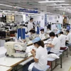 Des ouvriers d'une usine textile exportant des marchandises à Garco 10 à Hanoï. Photo : VNA