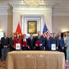 La cérémonie de signature d'un protocole d'accord entre des représentants vietnamiens et américains. Photo : VNA