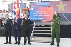 Le vice-Premier ministre Hô Quôc Dung remet symboliquement la deuxième tranche du programme de collecte de fonds « 65 ans d'amitié Vietnam-Cuba » organisé par la Croix-Rouge du Vietnam au vice-président cubain Salvador Valdés Mesa. Photo : VNA