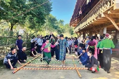 Des touristes visitant le Village culturel et touristique des ethnies du Vietnam. Photo : hanoimoi.vn