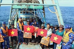 Les autorités distribuent des drapeaux nationaux et des gilets de sauvetage aux pêcheurs en mer. Source : VNA