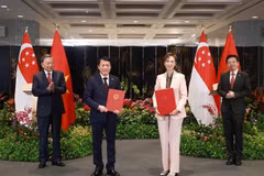Le secrétaire général du Parti communiste du Vietnam (PCV), Tô Lâm (à gauche), et le Premier ministre singapourien, Lawrence Wong (à droite), assistent à l'échange d'un protocole d'accord sur la transformation numérique entre le ministère vietnamien de la Sécurité publique et le ministère singapourien du Développement numérique et de l'Information, le 12 mars. Photo : VNA
