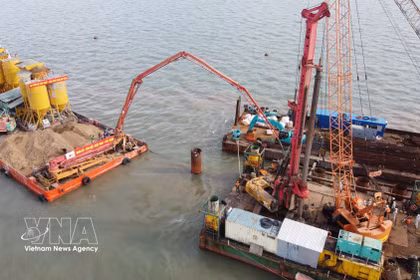 Des ingénieurs et ouvriers travaillent sur le chantier du projet de liaison vers l’île de Hon Khoai. Photo : VNA