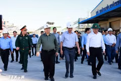 Le Premier ministre Pham Minh Chinh (chemise grise) visite des sites de production endommagés par le typhon Kalmaegi dans la zone économique de Nhon Hoi. Photo : VNA