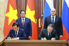 Les Premiers ministres vietnamien Pham Minh Chinh (gauche, 2e ligne) et russe Mikhaïl Michoustine (droite, 2e ligne) assistent à la signature de l'accord de coopération pour la construction d'une centrale nucléaire au Vietnam. Photo : VNA