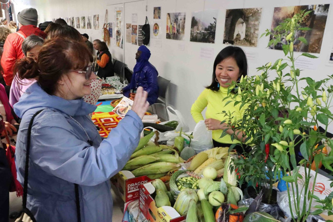Les visiteurs découvrent les fruits et légumes tropicaux au stand vietnamien. Photo : VNA paix-1.jpg
