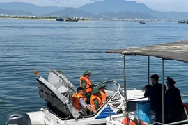 Des gardes-frontières contrôlent les papiers de départ des bateaux de pêche. Photo: VNA