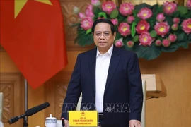Le Premier ministre Pham Minh Chinh lors de la réunion sur la « Campagne Quang Trung », une opération éclair visant la reconstruction des habitations dévastées par les récentes catastrophes naturelles. Photo : VNA