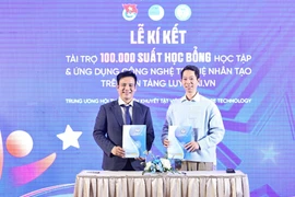 Pham Van Thanh, président de l'Association des jeunes handicapés du Vietnam (à gauche), signe un accord de coopération avec JMB Vietnam et InfoRe Technology pour financer 100 000 bourses d'études sur l'utilisation des outils d'IA sur la plateforme LuyenAI.vn. Photo : VNA