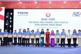 La directrice générale de l'Agence vietnamienne d'Information, Vu Viet Trang, remet des certificats de mérite aux personnes ayant accompli des réalisations exceptionnelles dans le mouvement d'émulation pour la période 2020-2025. (Photo : VNA)