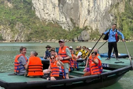 Des touristes visitent la Baie d'Ha Long. Photo : VNA