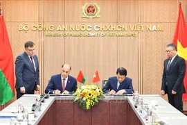 Le ministre vietnamien de la Sécurité publique, le général Luong Tam Quang (droite) et le secrétaire d'État du Conseil de sécurité de la Biélorussie, Volfovich Aleksandr Grigorievich signent un protocole d'accord portant création d'un groupe de travail conjoint visant à élargir et à renforcer la coopération en matière de sécurité. Photo : VNA
