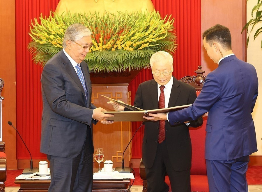 Le président du Kazakhstan Kassym-Jomart Tokayev (gauche) remet le 21 août 2023 à Hanoï au secrétaire général Nguyên Phu Trong (centre) un album de photos d’archives sur la visite du Président Hô Chi Minh au Kazakhstan en 1959. Photo : VNA