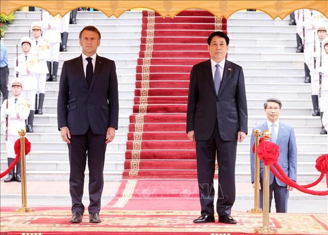 Le président vietnamien Luong Cuong et son homologue français Emmanuel Macron lors de la cérémonie d'accueil officiel à Hanoï. Photo : VNA