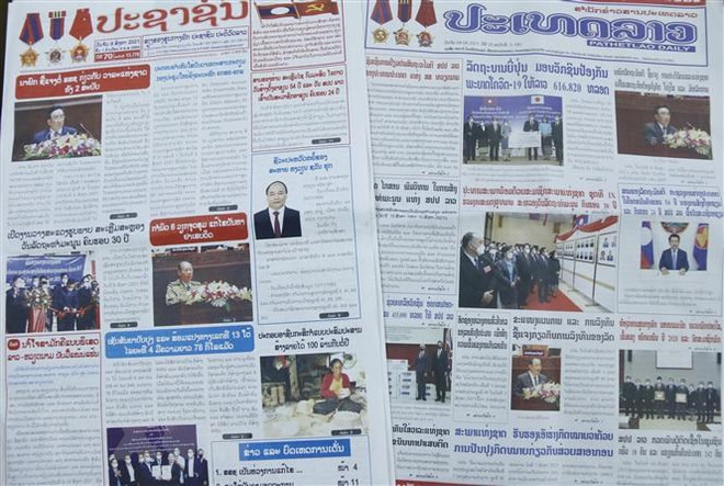 La presse lao couvre la visite d'amitié officielle du président Nguyen Xuan Phuc ảnh 2 La presse lao couvre la visite d'amitié officielle du président Nguyen Xuan Phuc ảnh 2