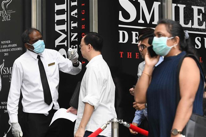 Singapour prend des mesures supplémentaires face au COVID-19 ảnh 1