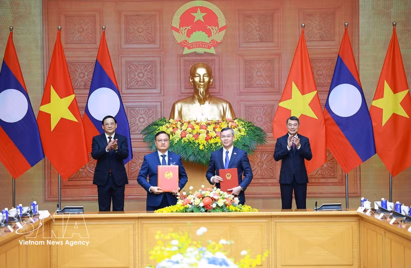 Les deux ministres des Finances du Vietnam et du Laos procèdent, le 7 juin à Hanoi, à l’échange officiel de leur accord de coopération pour la période 2026-2030, en présence des Premiers ministres des deux pays. Photo: VNA