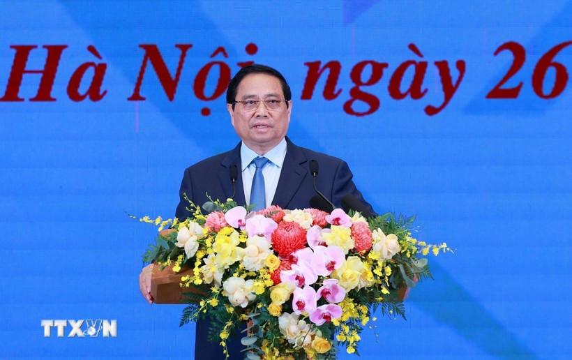 Le Premier ministre Pham Minh Chinh, président du Conseil central de l'émulation et des récompenses et chef du Comité directeur central pour l’éradication des maisons temporaires et délabrées à l’échelle nationale, s'exprime lors de la conférence. Photo: VNA