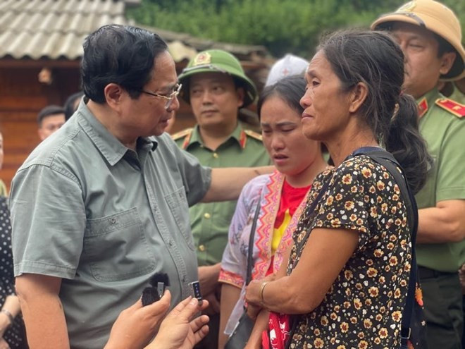 Le Premier ministre Pham Minh Chinh (gauche) et les sinistrées à Diên Biên. Photo: VNA