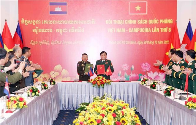 Le général de corps d'armée Hoàng Xuân Chiên (à droite) et le général Chay Saingyun signent le mémorandum d'entente entre les ministères de la Défense des deux pays sur la coopération dans le domaine du droit militaire et de la défense et le procès-verbal du dialogue. Photo : VNA vna-potal-doi-thoai-chinh-sach-quoc-phong-viet-nam-campuchia-lan-thu-8-stand-1.jpg