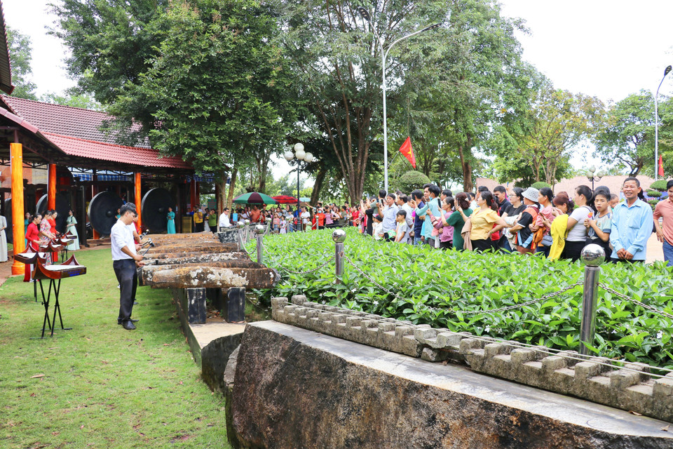 Des touristes assistent à une démonstration de lithophone dans la zone de préservation culturelle de l'ethnie minoritaire S'tiêng, située dans la commune de Bom Bo, province de Dông Nai.