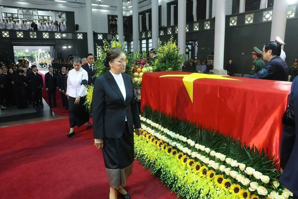 La vice-présidente lao Pany Yathotou fait le tour du cercueil pour la dernière fois, faisant ses adieux à l'ancien président Tran Duc Luong. Photo : VNA