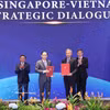 Le membre du Bureau politique et ministre des Affaires étrangères Lê Hoài Trung et le ministre singapourien des Affaires étrangères Vivian Balakrishnan échangent la Déclaration commune sur la Stratégie de connectivité technologique Vietnam-Singapour. Photo: VNA