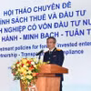 Le directeur du Département des impôts, Mai Xuan Thanh, s'exprime lors du séminaire. Photo: VNA