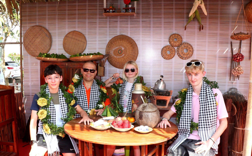 Des touristes prennent des photos dans l’espace « Bếp xưa », recréant la cuisine traditionnelle des habitants du Sud du Vietnam. Photo : VNA