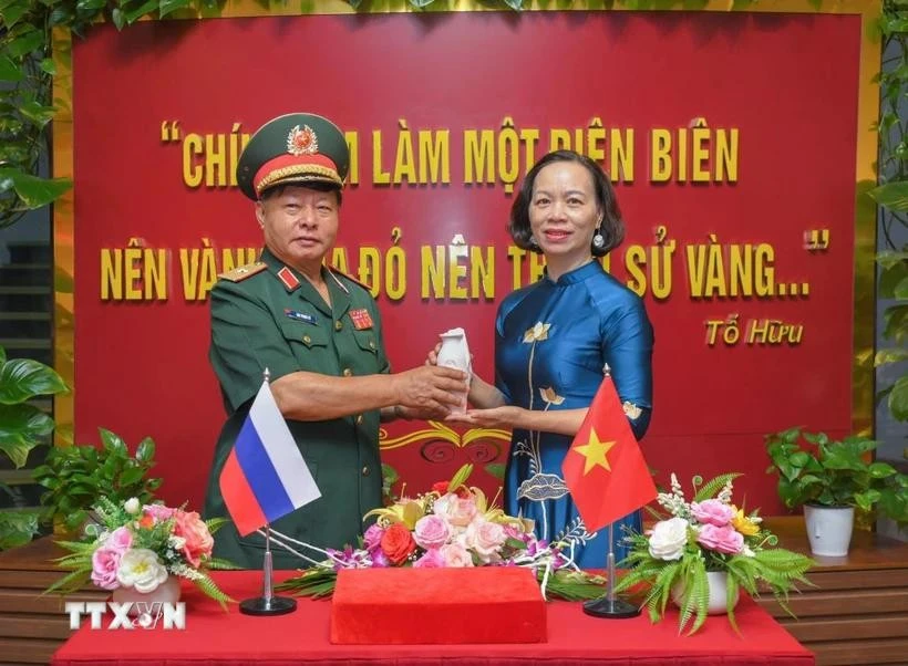 Le général Luu Trong Lu, président de l’Association des anciens combattants de la province de Diên Biên, remet l’urne contenant la terre sacrée à Vu Thi Tuyet Nga, directrice du Musée de la Victoire de Diên Biên Phu. Photo : VNA