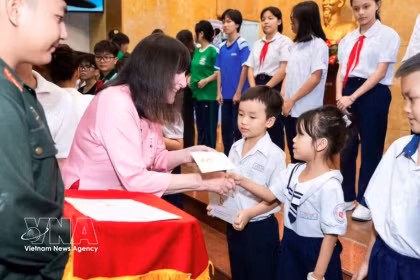 Julia Morley, présidente de Miss Monde, remet des cadeaux à des enfants et des femmes défavorisés lors du programme de charité «Joyeuse Journée des enfants» au Vietnam. Photo : VNA