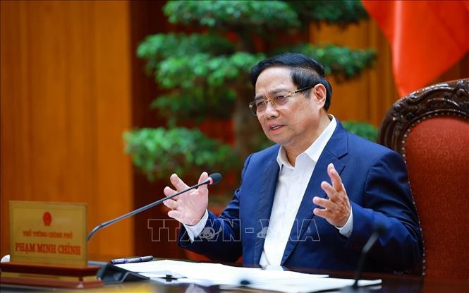 Le Premier ministre Pham Minh Chinh s'exprime lors de la réunion, à Hanoi, le 24 décembre. Photo: VNA