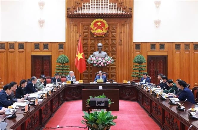 Le Premier ministre Pham Minh Chinh (centre) préside la 7e réunion du comité de pilotage du gouvernement, à Hanoi, le 2 janvier. Photo : VNA