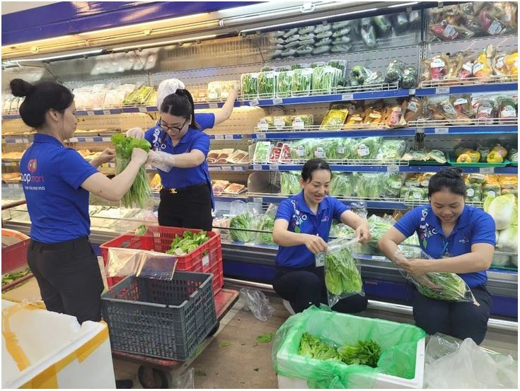 Le personnel de Co.opmart s'affairent à réapprovisionner les marchandises. Photo: Saigon Co.op