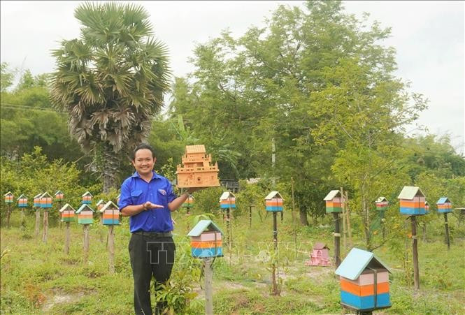 Nguyên Trung Thành montrant une ruche d'abeille dans son jardin. Photo: VNA